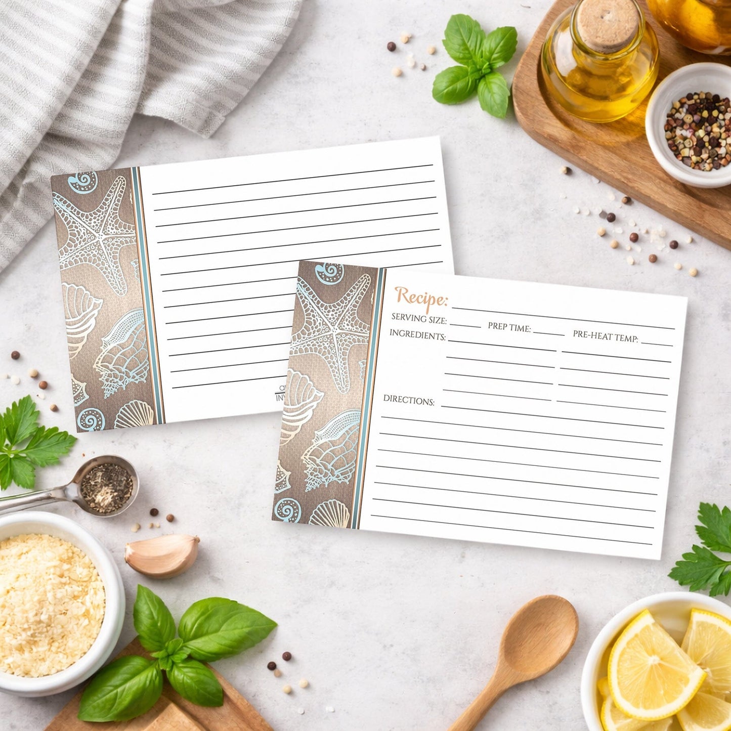 Set of Rustic Wood Beach Seashell Recipe Cards with a coastal design on a kitchen counter with ingredients and utensils.