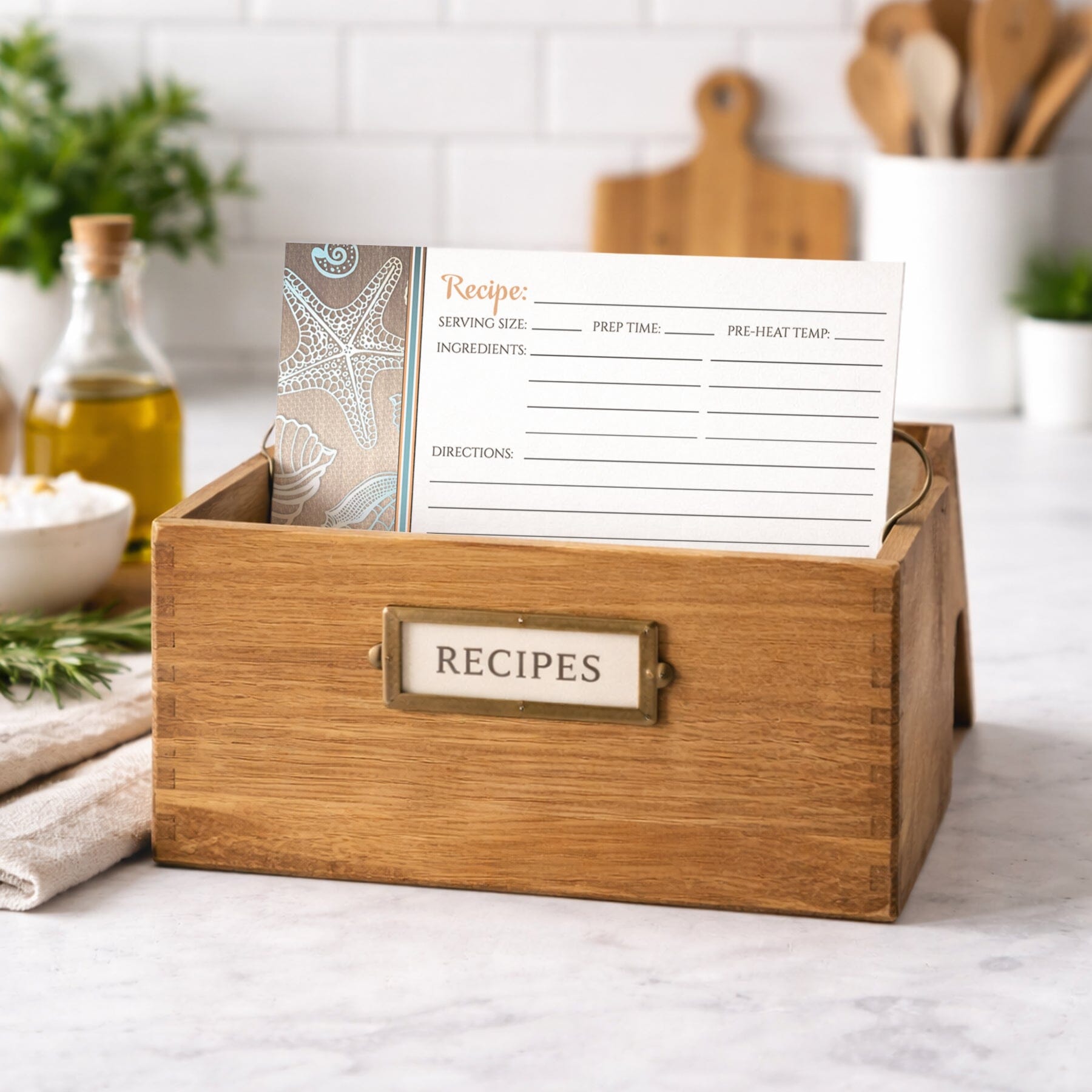 Wooden recipe box with a Rustic Wood Beach Seashell Recipe Card on a kitchen counter