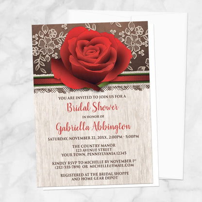 Bridal shower invitation with a large red rose, rustic wood, and illustrated lace, displayed with a white envelope on a marble surface