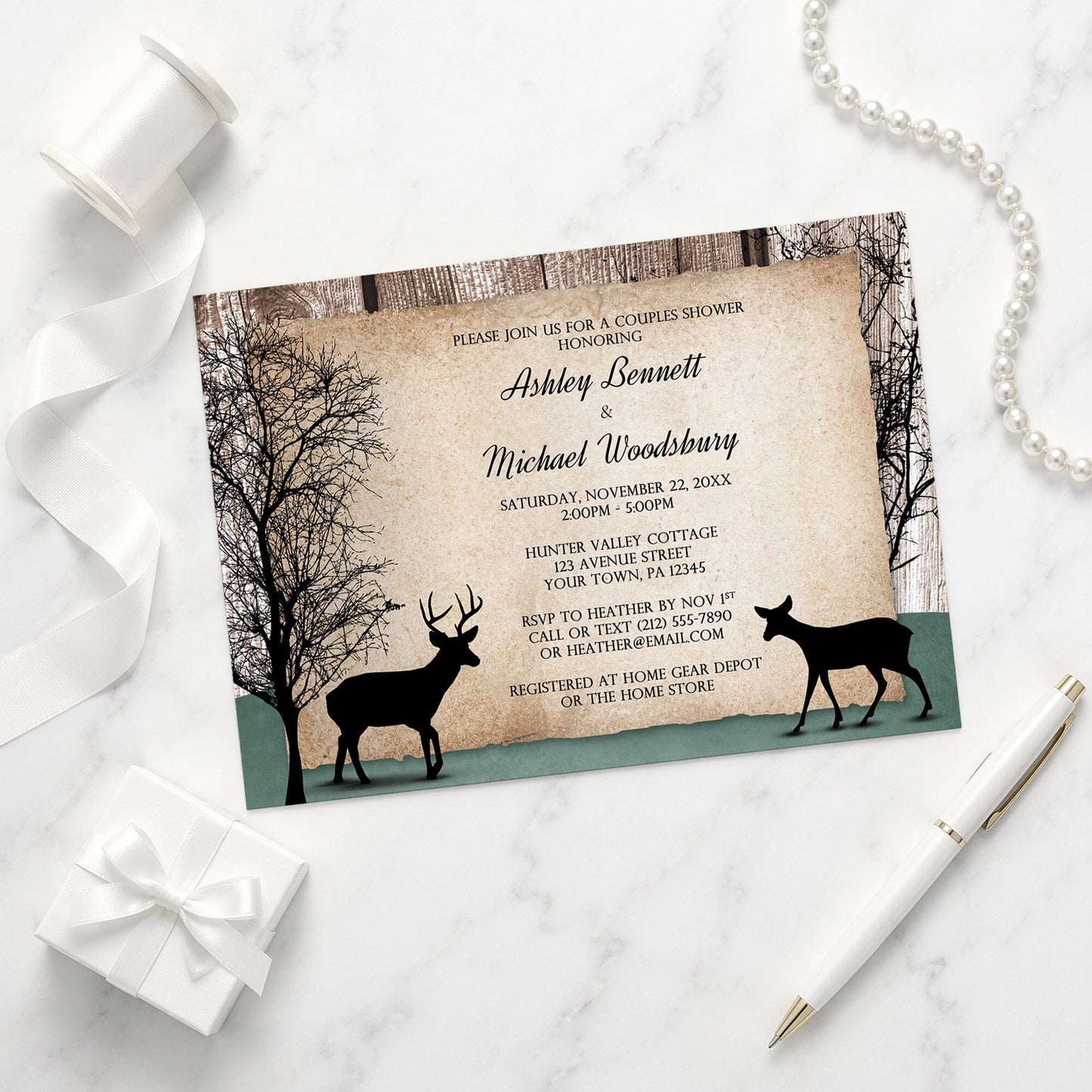 Rustic Woodsy Deer Couples Shower Invitation shown on a marble surface with a white gift box, pen, ribbon, and pearls.