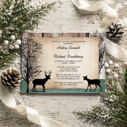 Rustic Woodsy Deer Couples Shower Invitation shown on a rustic wooden surface with winter greenery, ribbons, and pine cones.