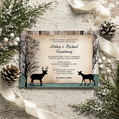 Rustic Woodsy Deer Vow Renewal Invitation shown on a wooden surface with winter greenery, ribbon, and pine cones.