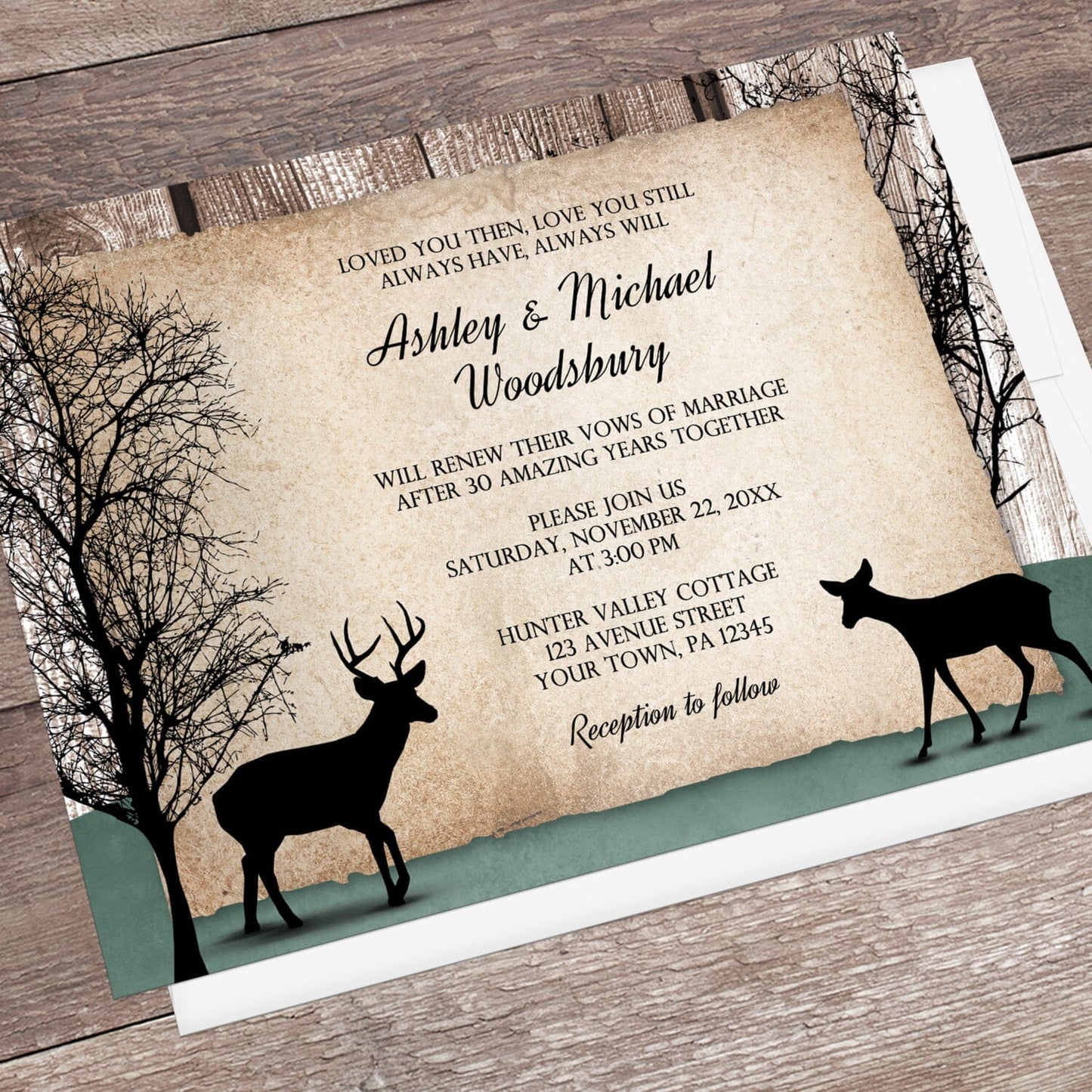 Rustic Woodsy Deer Vow Renewal Invitation shown at an angle on a brown wooden surface with a white envelope.
