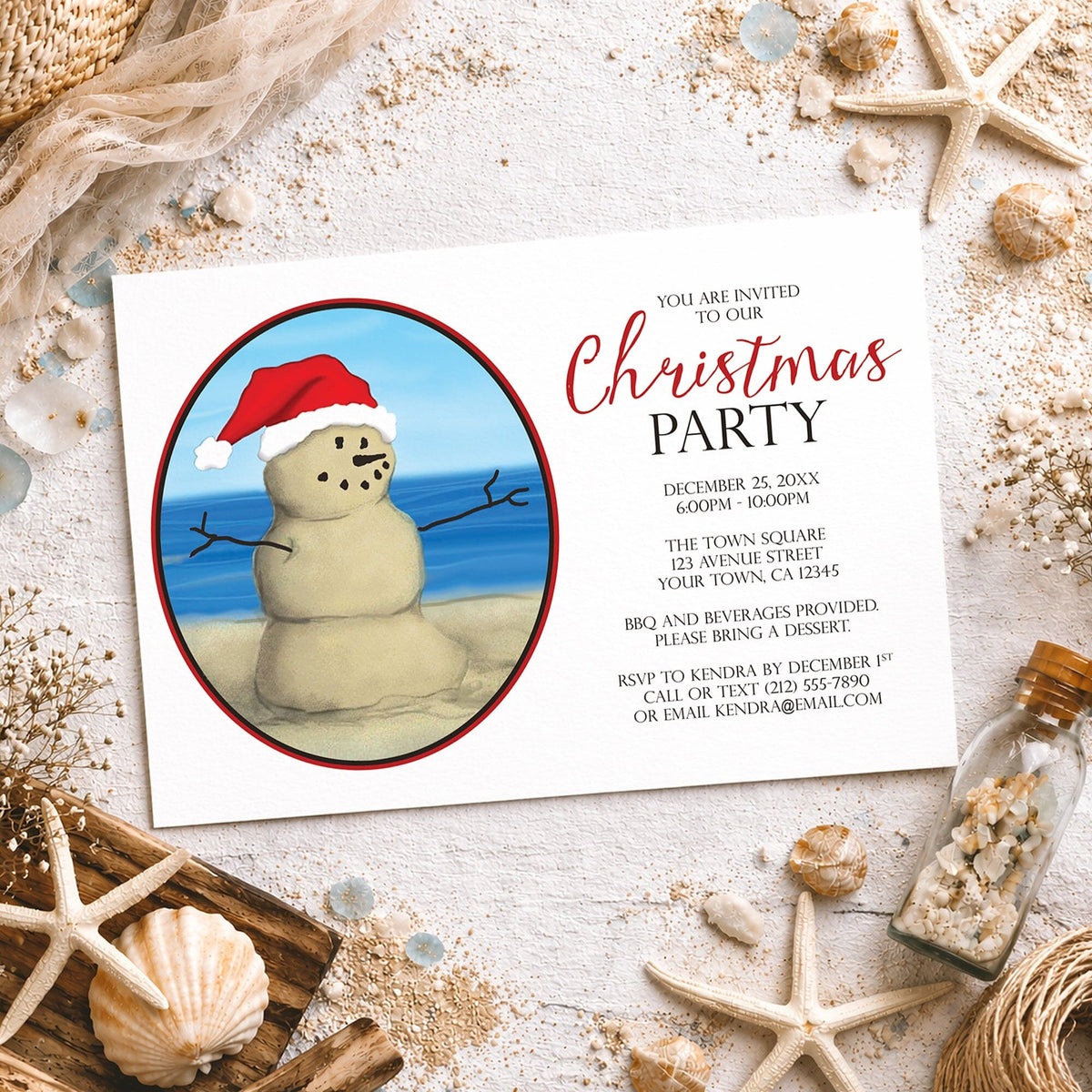 Sand snowman beach Christmas party invitation featuring a smiling sand snowman wearing a red Santa hat beside blue ocean water, with personalized Christmas party details in red and black on white, styled on a light rustic surface with seashells, starfish, sand, driftwood, and other coastal details.