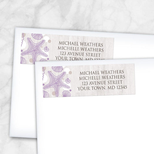 Seashell Whitewashed Wood Purple Beach Address Labels (shown on envelopes) at Artistically Invited. Modern and rustic seashell whitewashed wood purple beach address labels personalized with your return address. These beautiful address labels are designed with a purple seashell outline drawing, tan and white dots to the left side, over a light whitewashed wood background illustration. Your return address is personalized in a brown all-capital letters font over the whitewashed wood pattern.