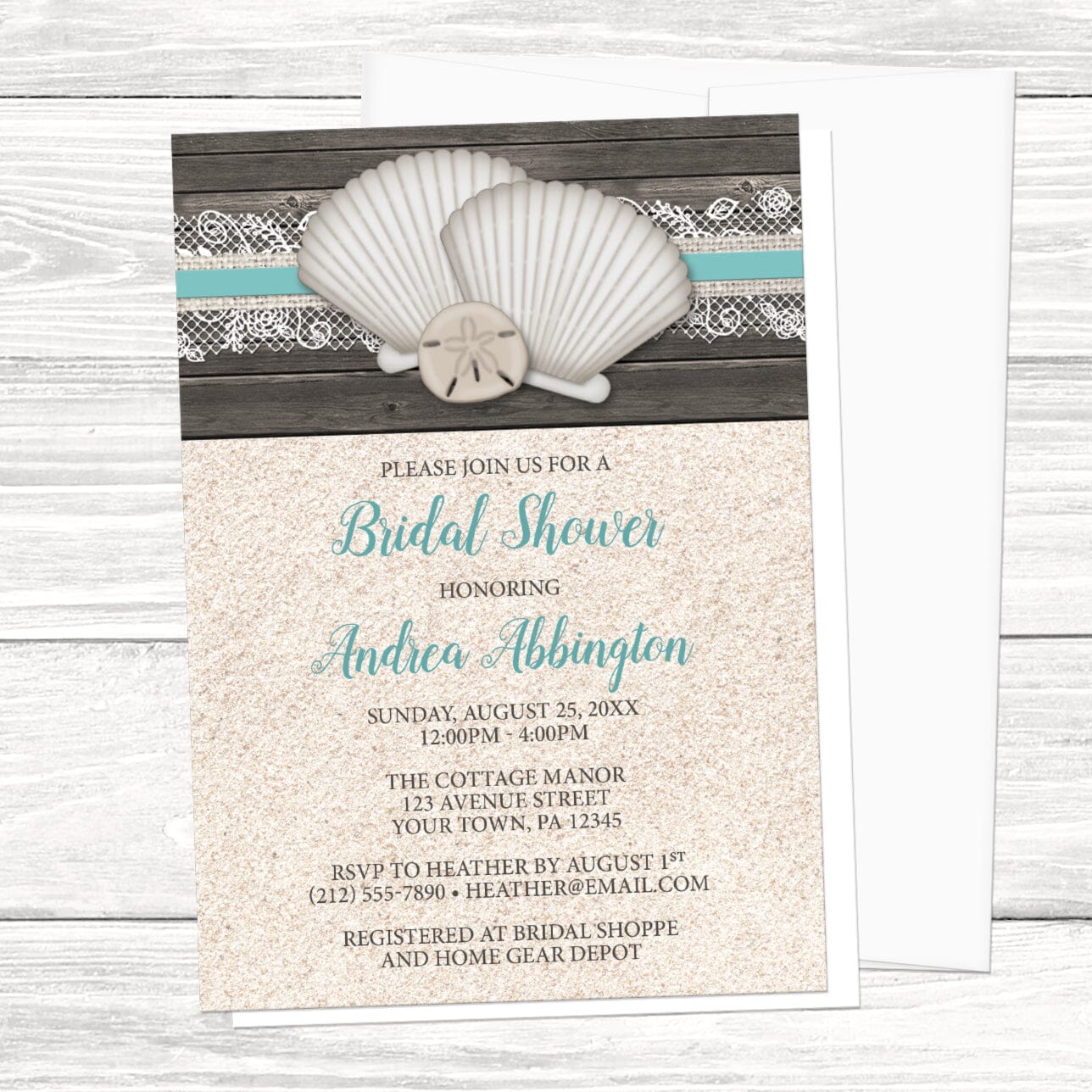 Beach-themed bridal shower invitation with shells, lace, wood, and sand, displayed with an envelope on a wooden background