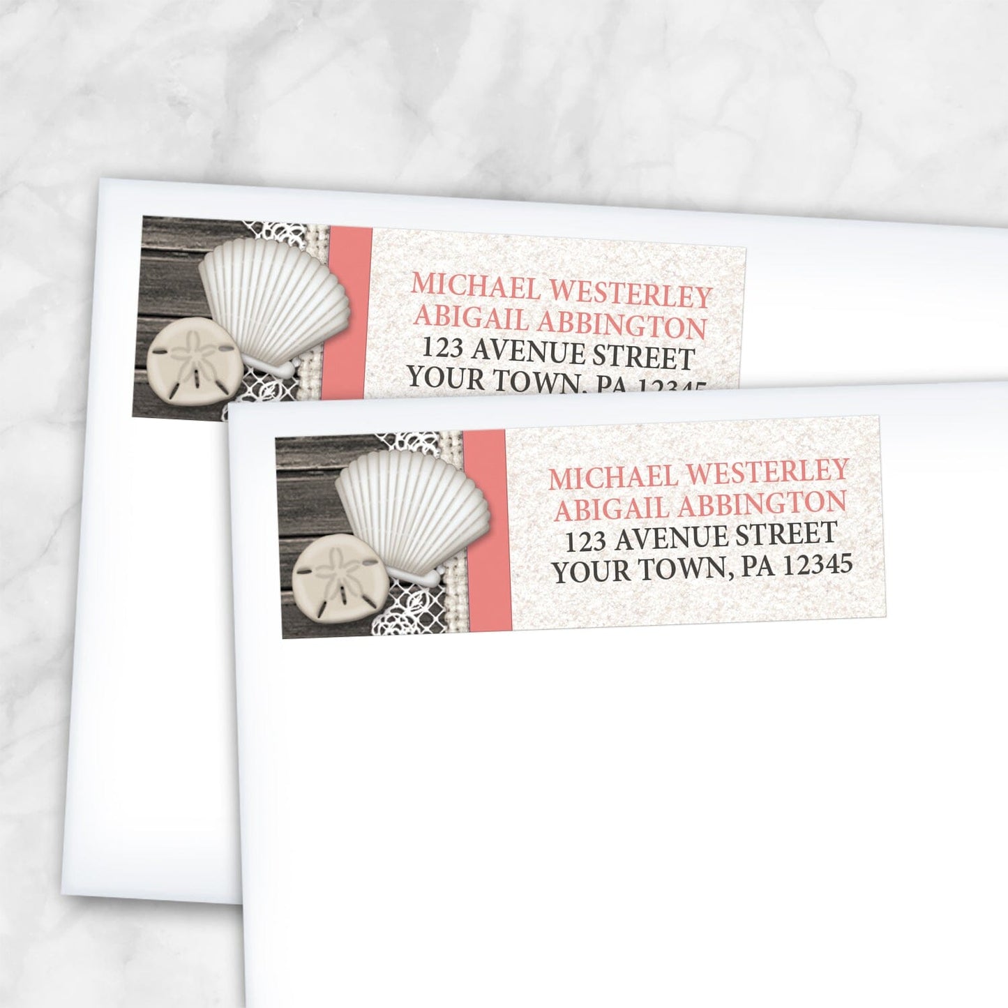 2 Seashell Lace Wood and Sand Coral Beach Address Labels shown on white envelopes on a marble surface