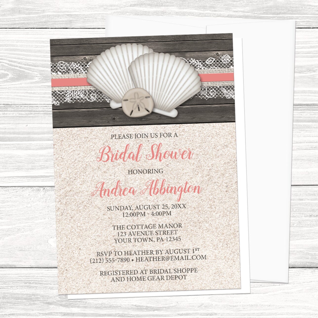 Beach bridal shower invitation with seashells and lace, wood, and sand, displayed with a white envelope on a white wood surface