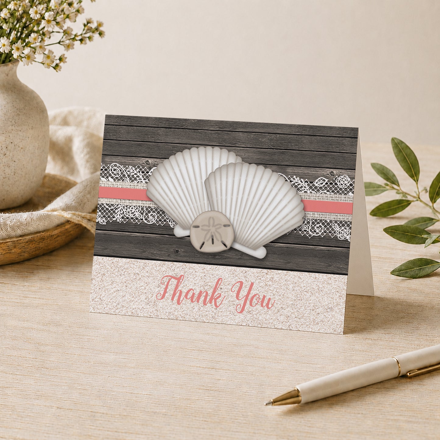 Seashell Lace Wood and Sand Coral Beach Thank You Card shown on a desk with a vase, plants, and a pen.