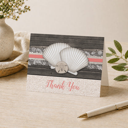 Seashell Lace Wood and Sand Coral Beach Thank You Card shown on a desk with a vase, plants, and a pen.