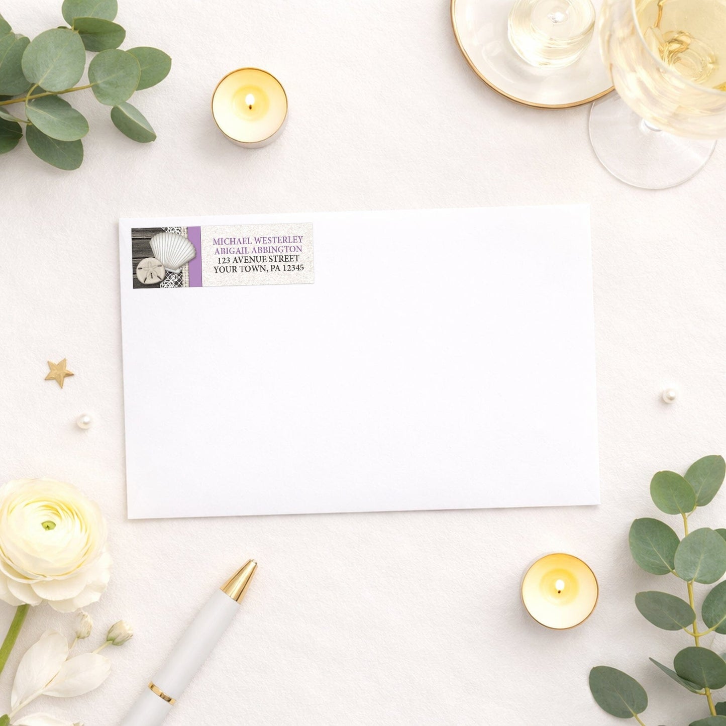 Seashell Lace Wood and Sand Purple Beach Address Label shown on a white envelope with wedding and shower supplies