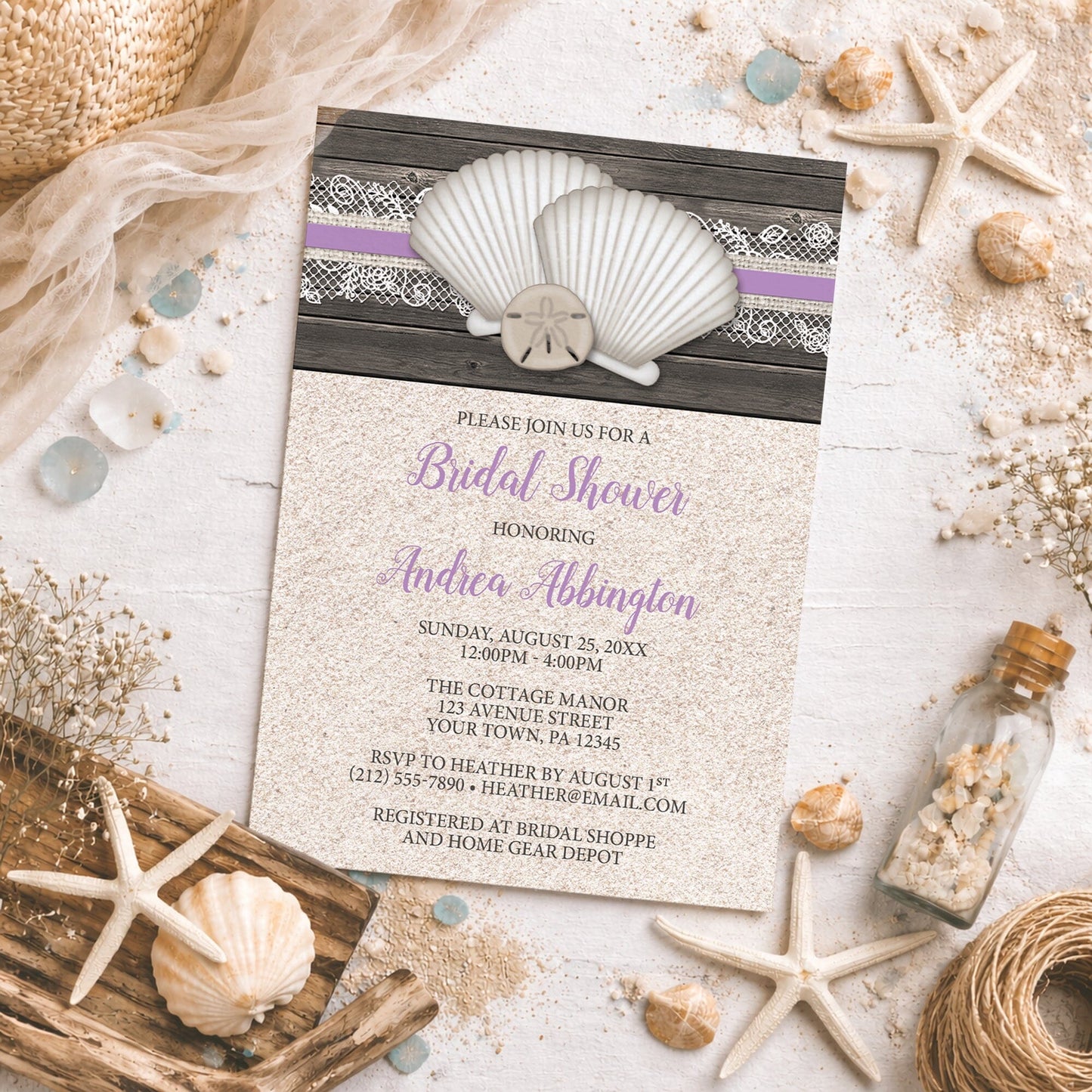 Seashell Lace Wood and Sand Purple Beach Bridal Shower Invitation on a rough surface with seashells and other beach-themed decor.