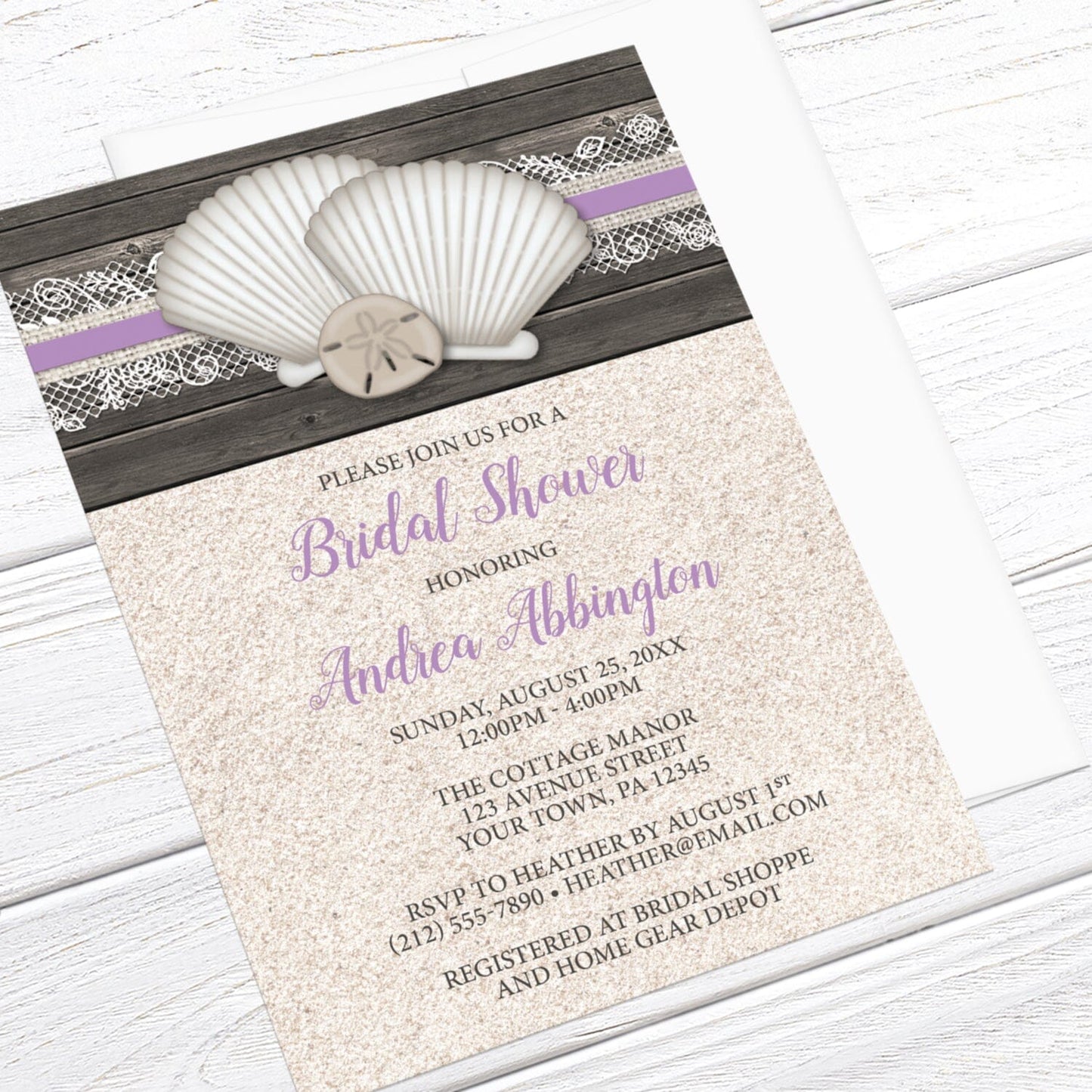 Seashell Lace Wood and Sand Purple Beach Bridal Shower Invitation shown at an angle on a light wood surface with a white envelope.