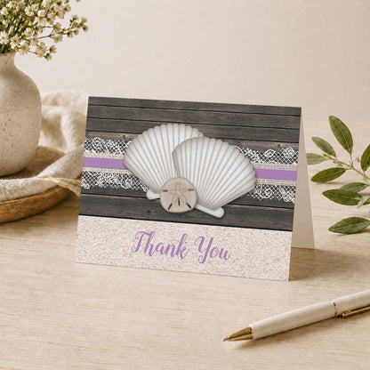 Seashell Lace Wood and Sand Purple Beach Thank You Card shown on a desk with a vase, plants, and a pen.