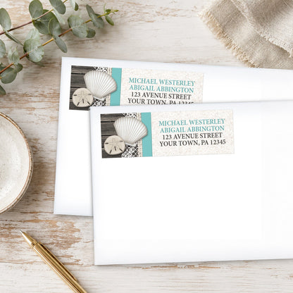 Seashell Lace Wood and Sand Teal Beach Address Labels on white envelopes shown on a wooden surface with eucalyptus leaves and a pen.