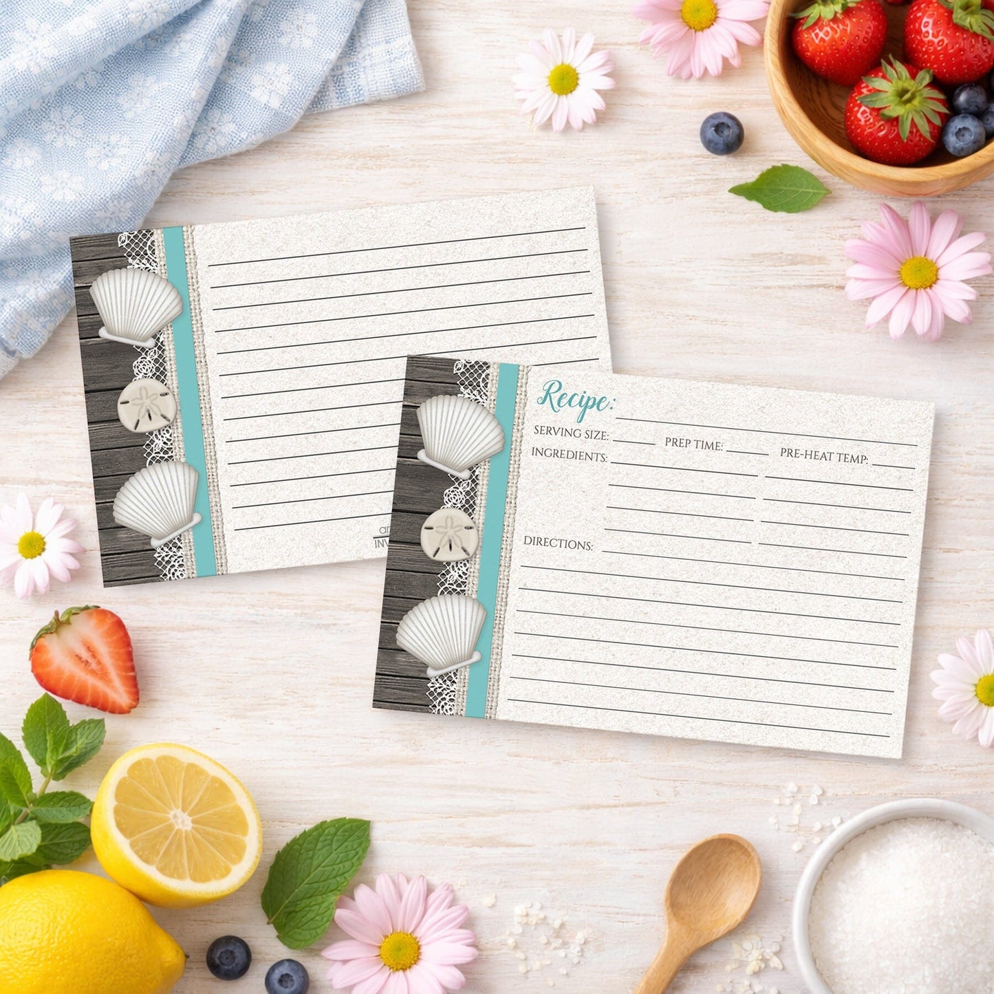 Set of Seashell Lace Wood and Sand Teal Beach Recipe Cards on a wooden surface with spring and summer fruits and flowers.