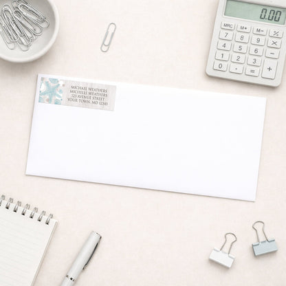 Seashell Whitewashed Wood Beach Address Label shown on a white envelope with everyday office supplies