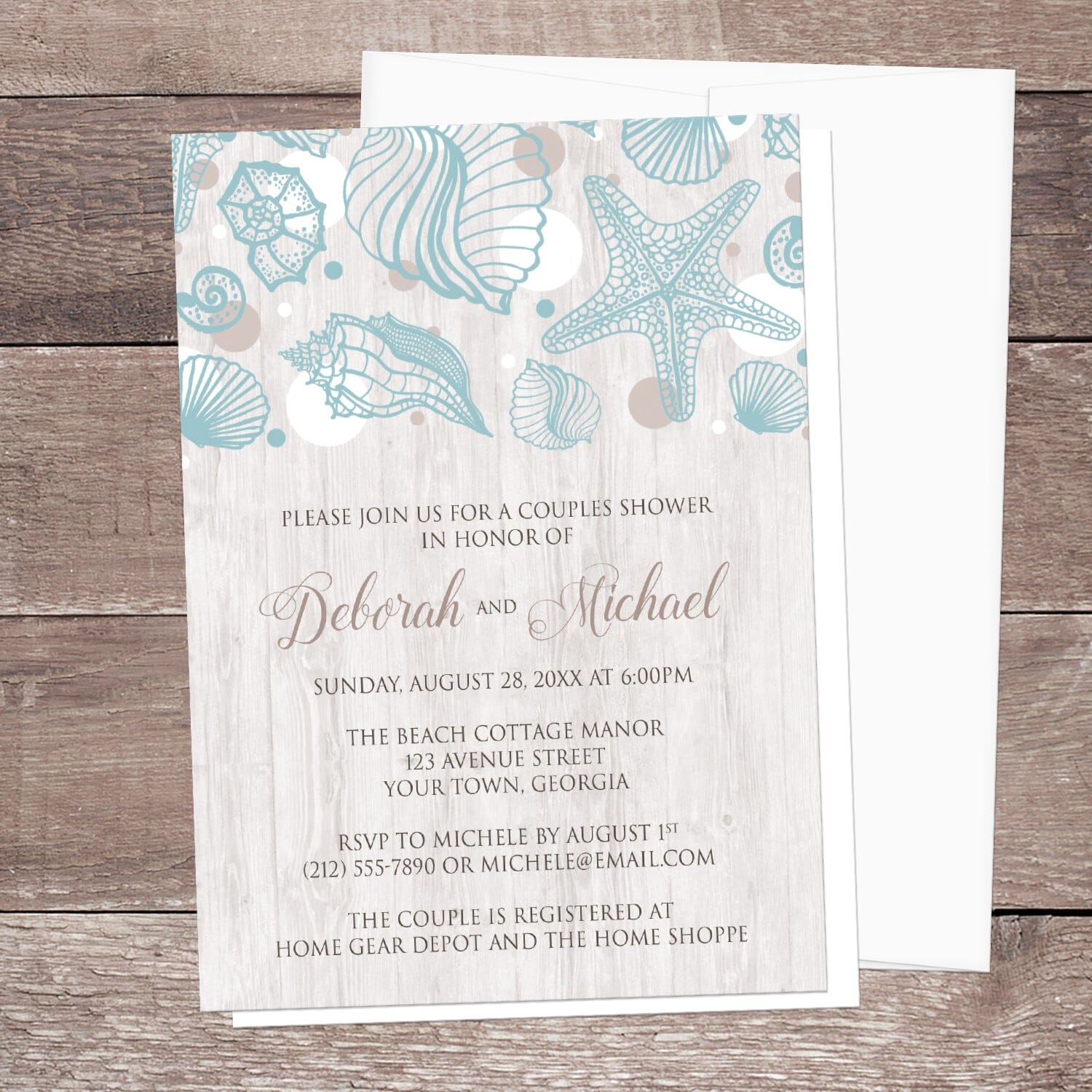 Seashell Whitewashed Wood Beach Couples Shower Invitation shown on a brown wood surface with a white envelope.