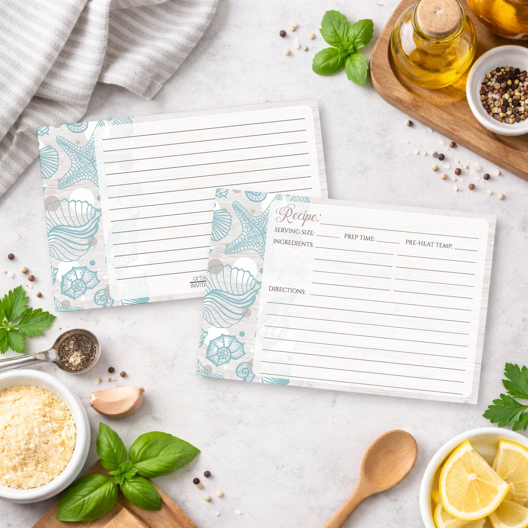 Set of Seashell Whitewashed Wood Beach Recipe Cards on a kitchen counter with ingredients and utensils.