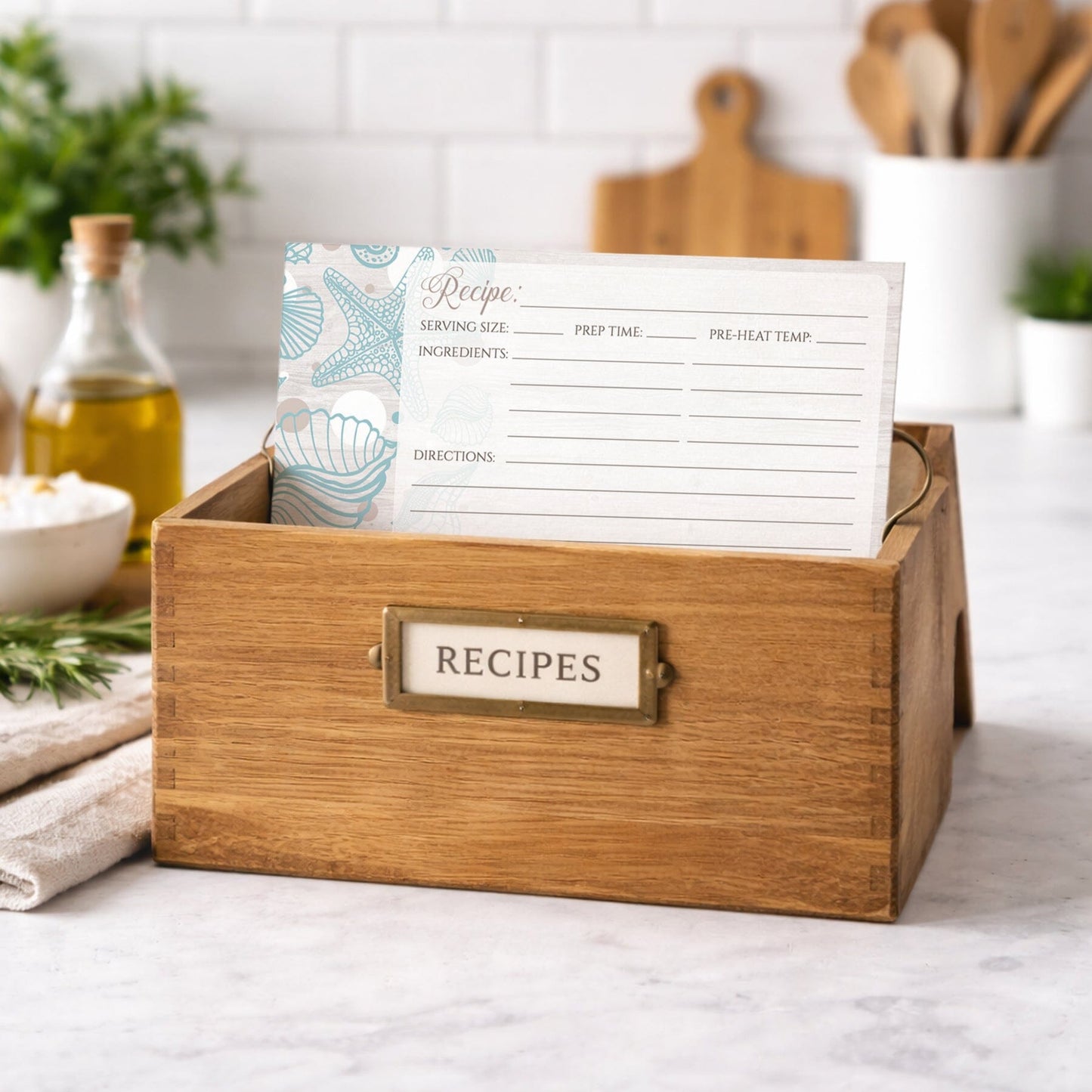 Wooden recipe box with a Seashell Whitewashed Wood Beach Recipe Card on top in a kitchen setting