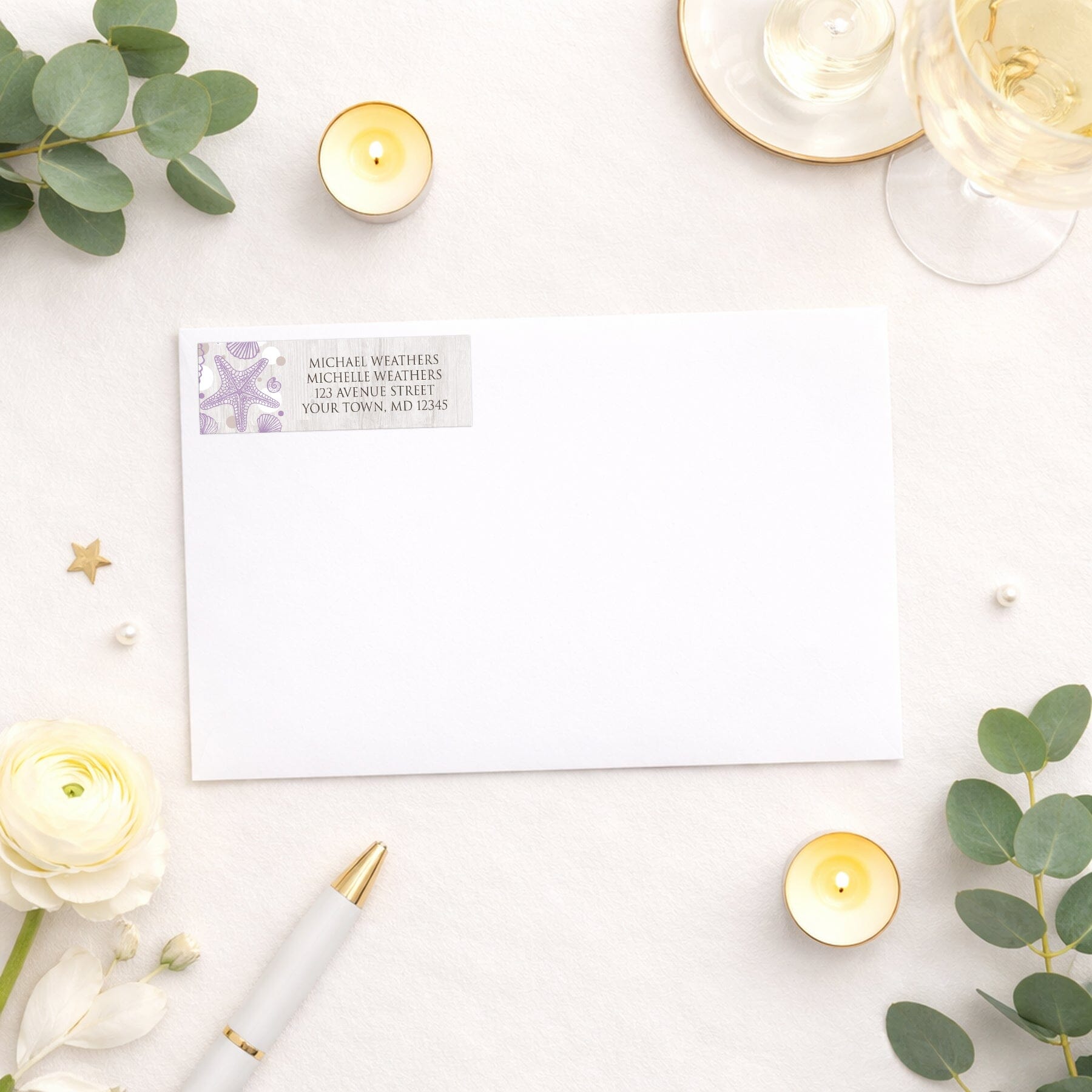 Seashell Whitewashed Wood Purple Beach Address Label shown on a white envelope with wedding or shower supplies