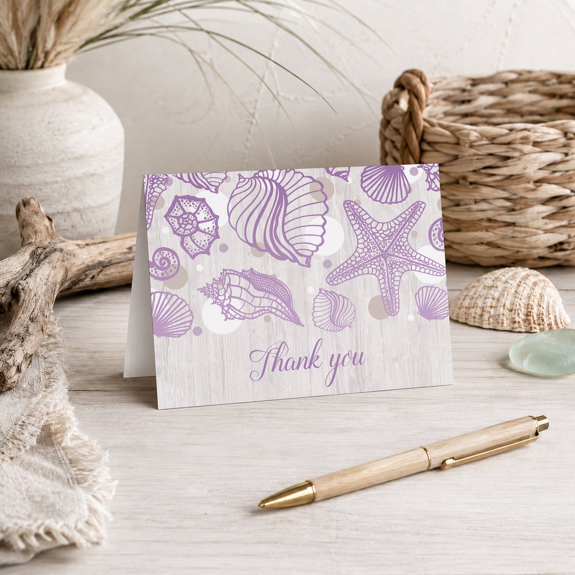 Seashell Whitewashed Wood Purple Beach Thank You Card shown on a beach house tabletop with a vase, coastal decor, and a pen.