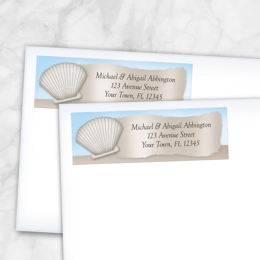 2 Seashell in the Sand Beach Address Labels shown on white envelopes on a marble surface