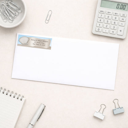 Seashell in the Sand Beach Address Label shown on a white envelope with office supplies