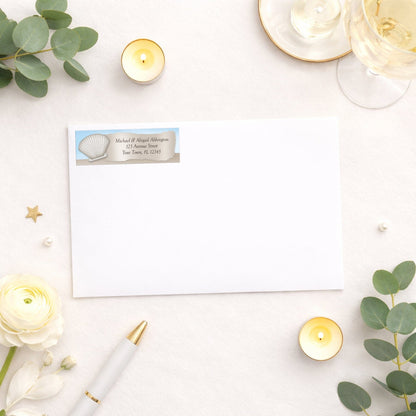 Seashell in the Sand Beach Address Label shown on a white envelope with wedding or shower supplies