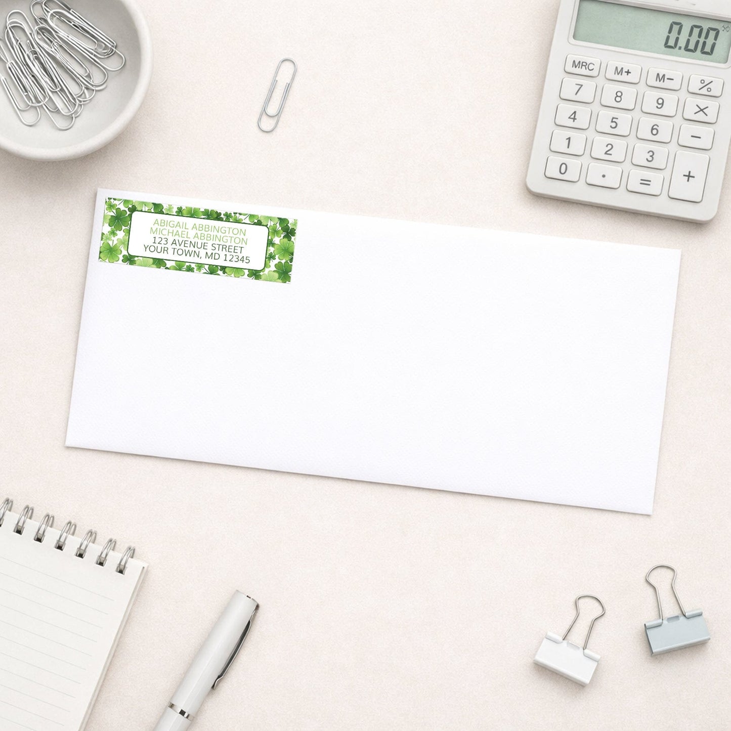 Shamrocks and 4-Leaf Clovers Address Label shown on a white envelope with office supplies