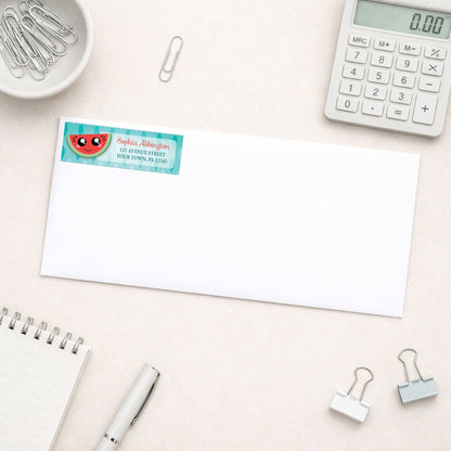 Smiling Watermelon Slice Address Label shown on a white envelope with everyday office supplies
