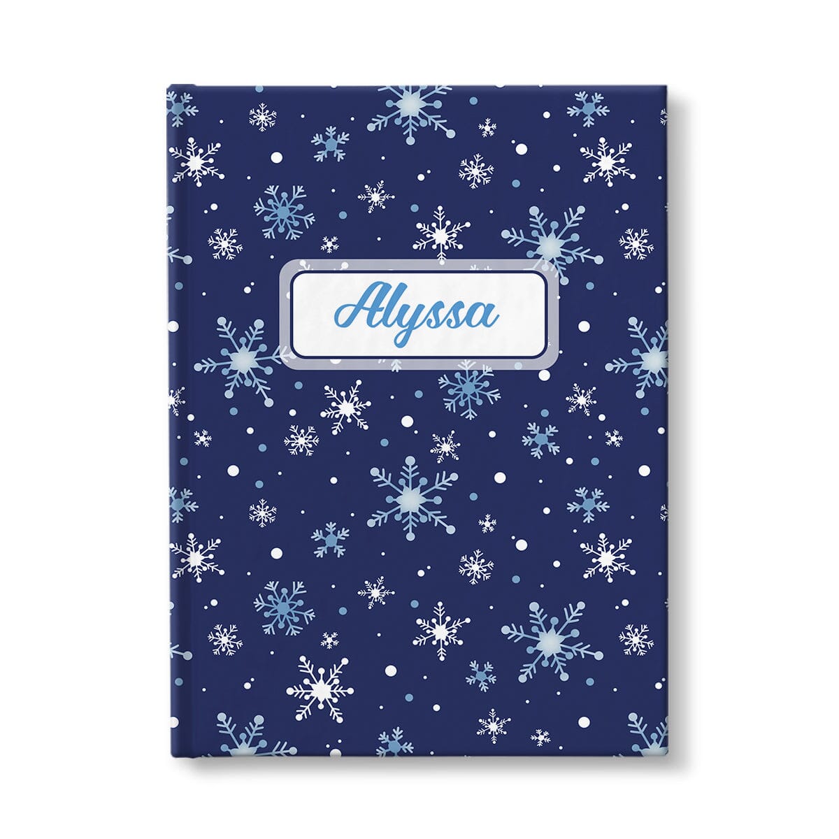 Personalized Snowflakes on Blue Journal at Artistically Invited. A custom book designed with a pattern of whimsically drawn white and blue snowflakes over a navy blue background that wraps around the journal. Your personalized name is custom printed in a blue script font within a white rectangular frame design over the snowflakes pattern.