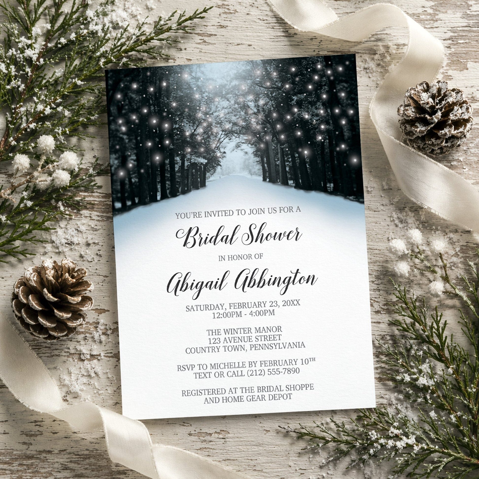 Winter-themed bridal shower invitation with snowy forest design on a rustic wooden surface with decorative elements.