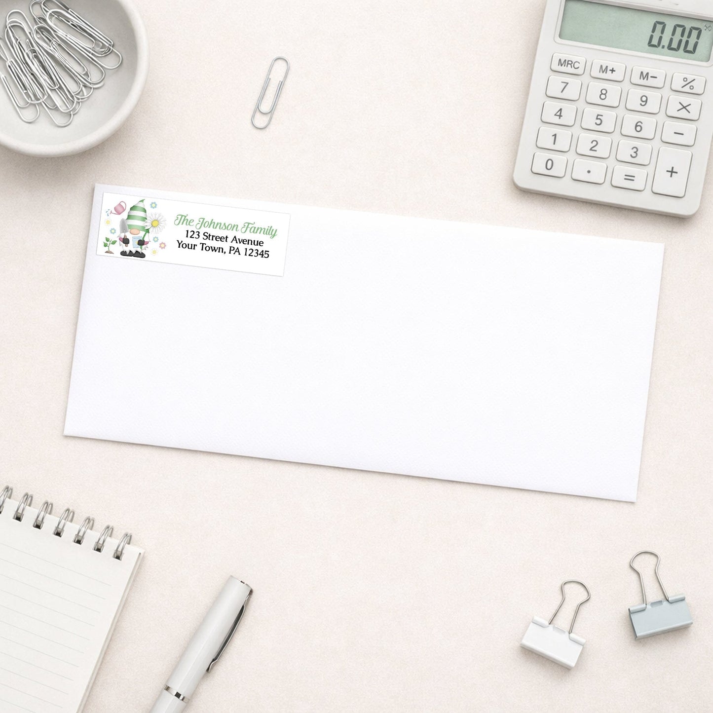 Spring Gardening Gnome Address Label shown on a white envelope with office supplies