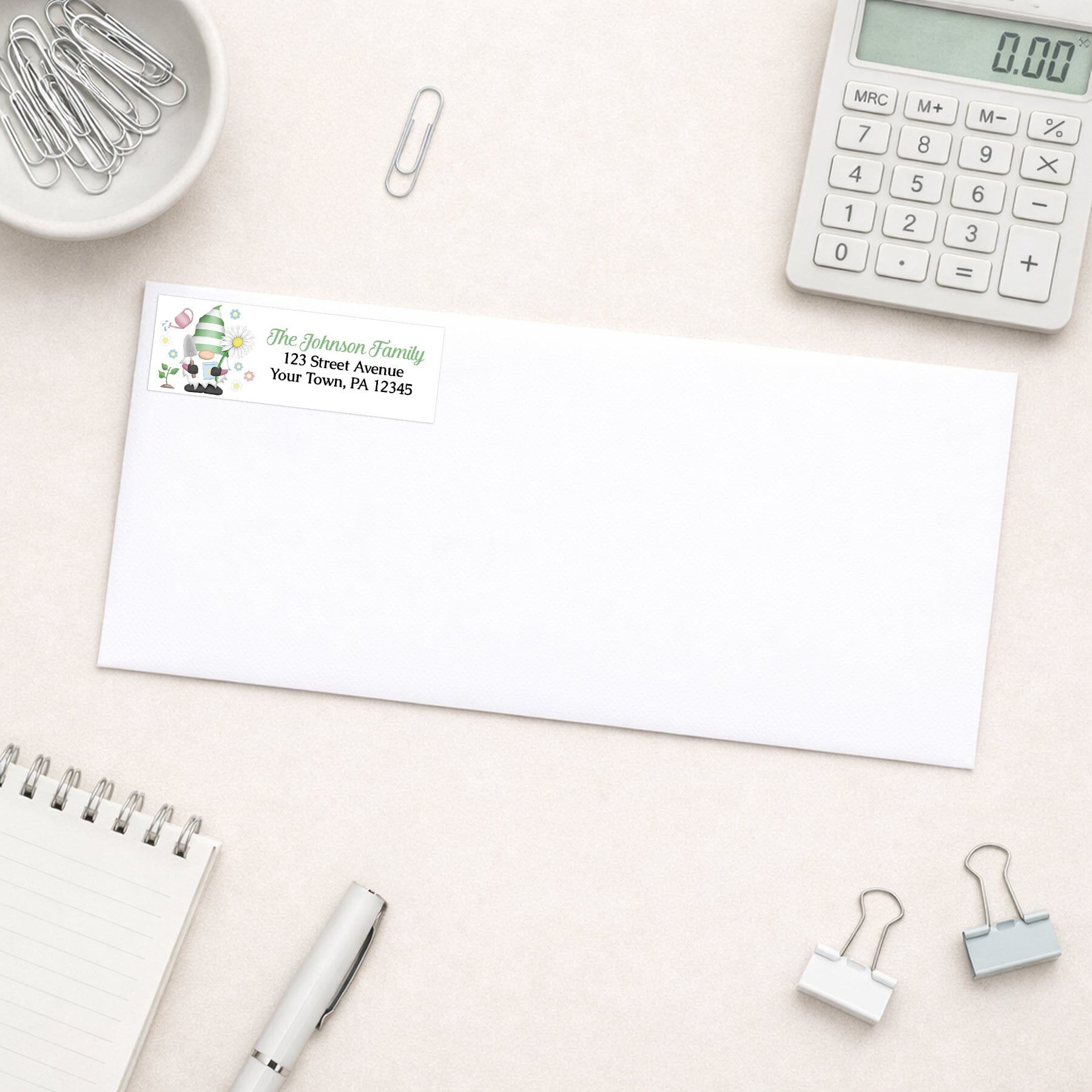 Spring Gardening Gnome Address Label shown on a white envelope with office supplies