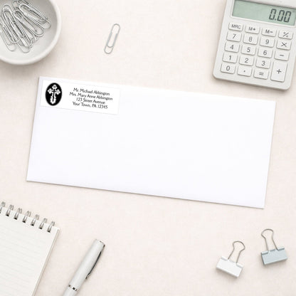 St. Olga Cross Orthodox Address Label shown on a white envelope with everyday office supplies