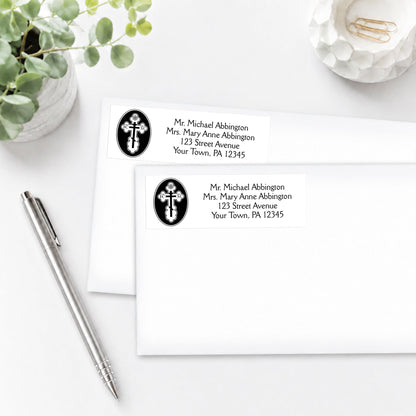 St. Olga Cross Orthodox Address Labels on white envelopes, shown on a white surface with a pen and plant.