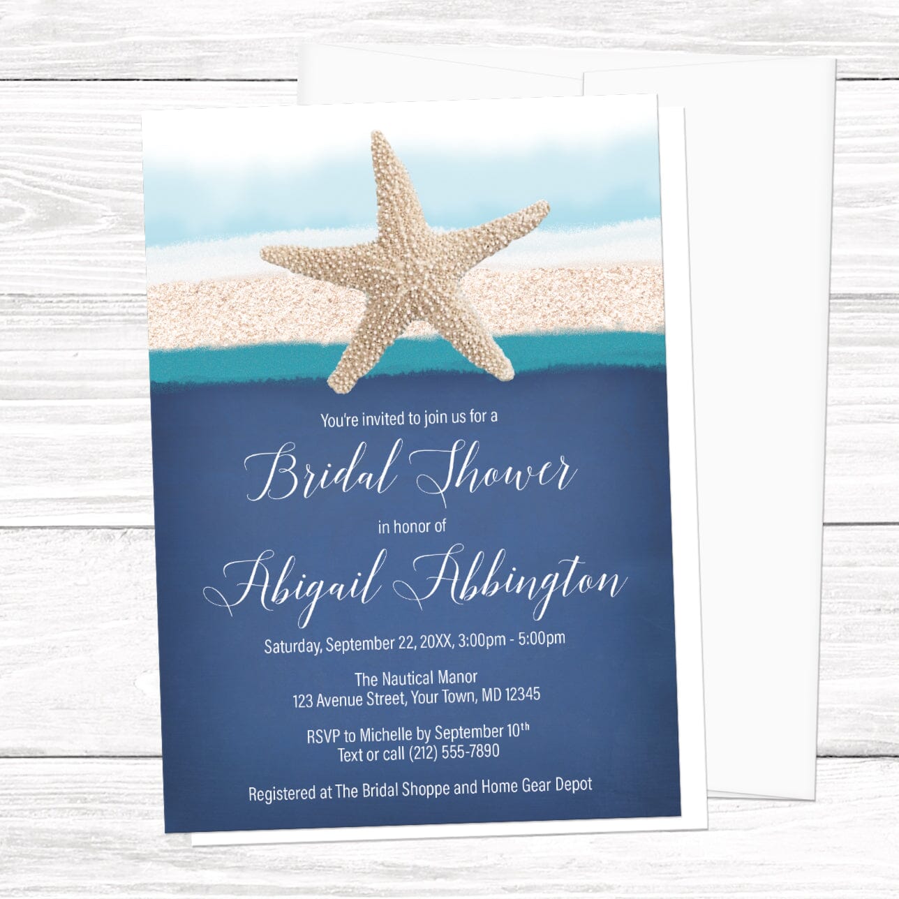 Beach bridal shower invitation with a starfish over sand, blue, and teal stripes, over a blue background for your personalization details in white, displayed with a white envelope on a white wood surface