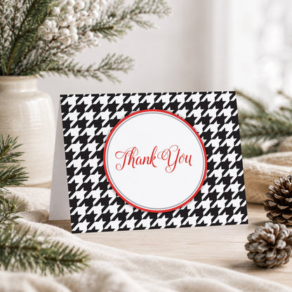 Stylish Black Houndstooth Red Thank You Card shown on a tabletop with a vase, winter greenery, and pine cones.