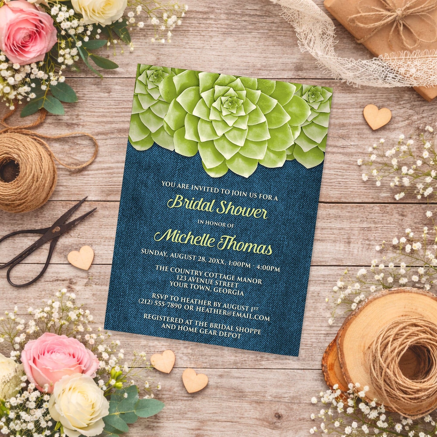 Succulent Green Blue Denim Bridal Shower Invitation shown on a country-inspired wooden background with spring and summer flowers, small wood hearts, and twine.