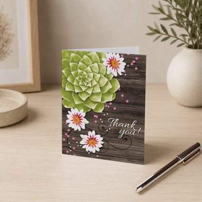 Succulent Rustic Floral Wood Thank You Card on a desk with a vase and a pen.
