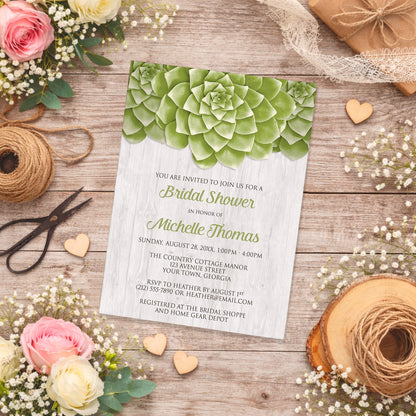 Bridal shower invitation with green succulent design shown on a wooden surface with spring and summer flowers and twine.