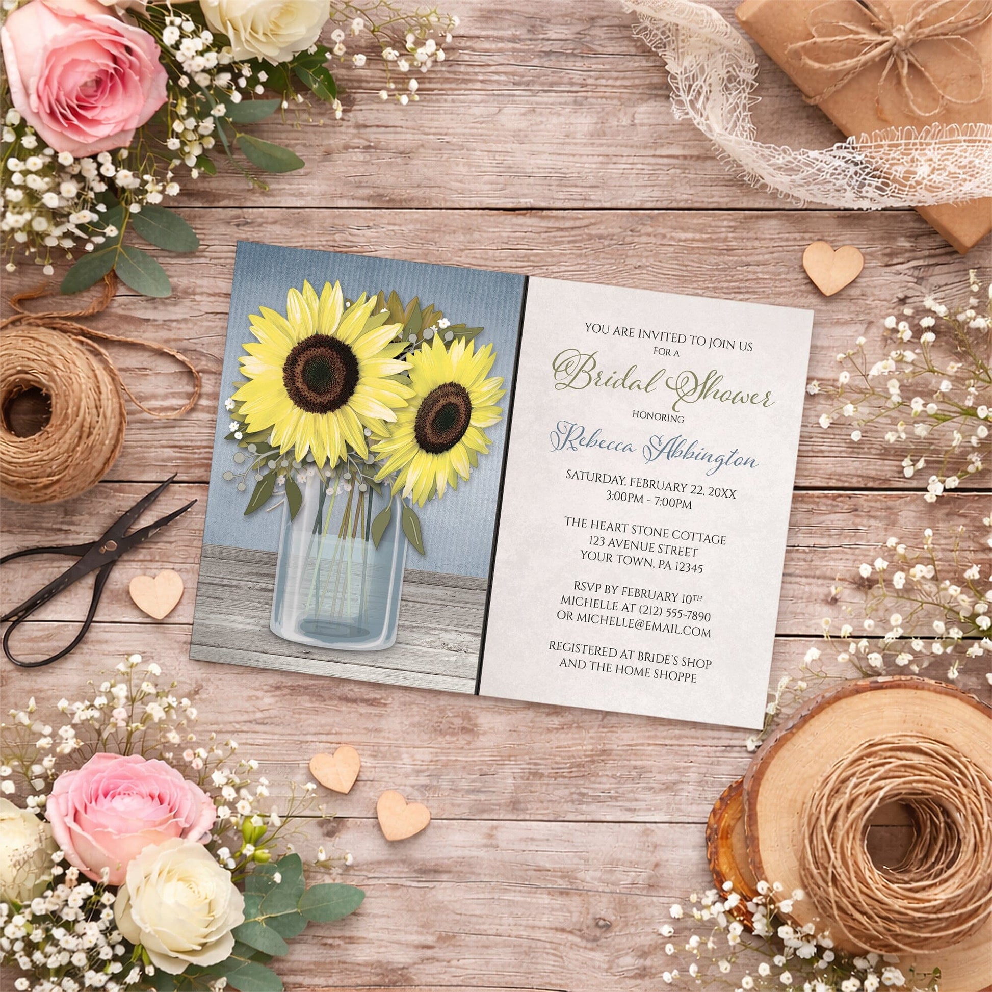 Sunflower Blue Mason Jar Rustic Bridal Shower Invitation shown on a wooden surface with summer flowers, small wood hearts, and twine.