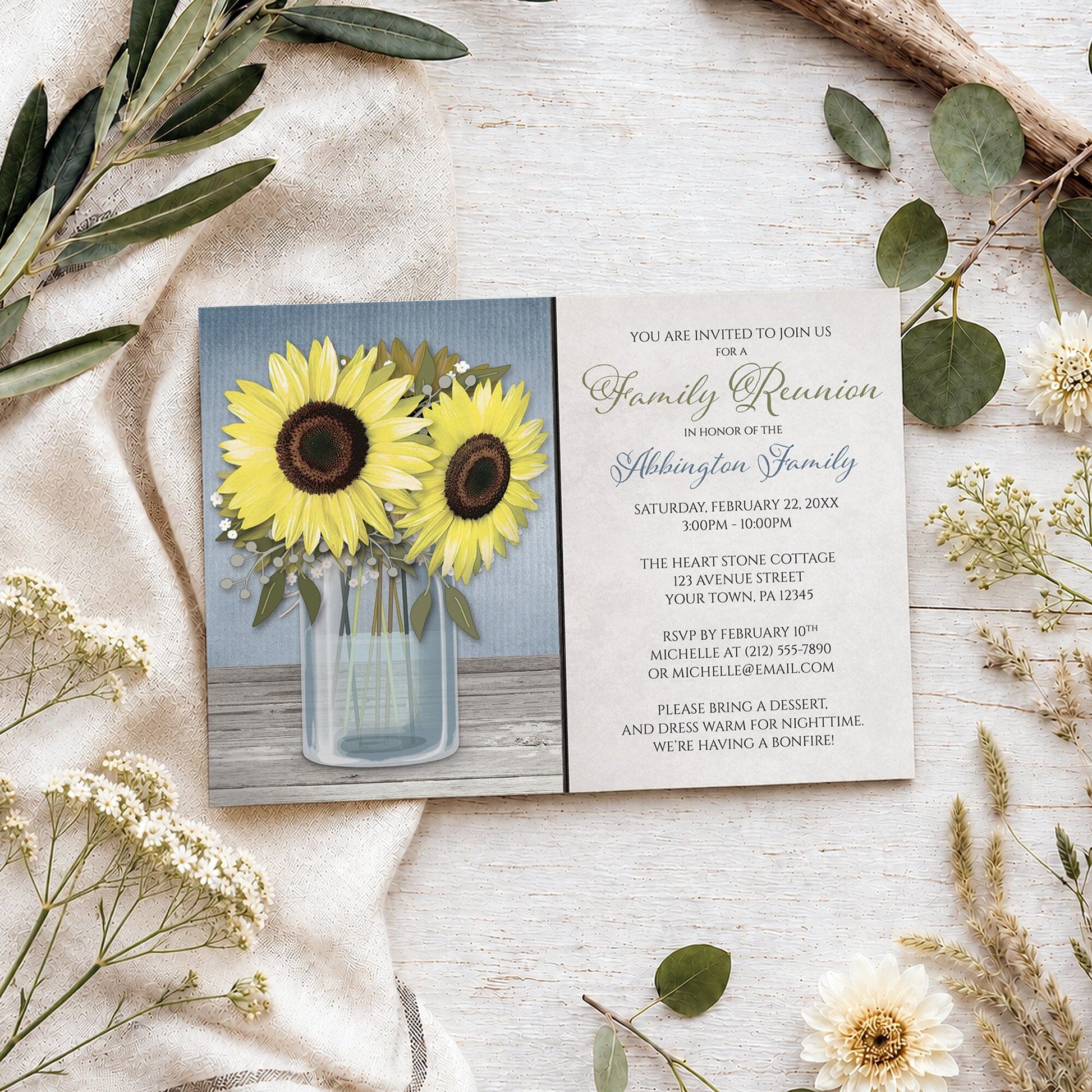 Sunflower Blue Mason Jar Rustic Family Reunion Invitation shown on a wooden surface with spring and summer plants.