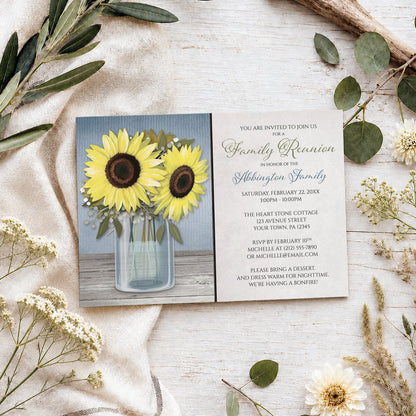 Sunflower Blue Mason Jar Rustic Family Reunion Invitation shown on a wooden surface with spring and summer plants.