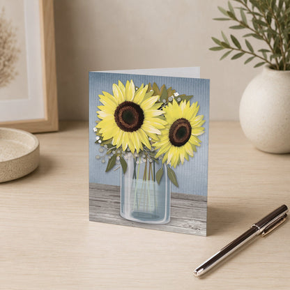 Sunflower Blue Mason Jar Rustic Note Card shown on a desk with a vase and a pen.