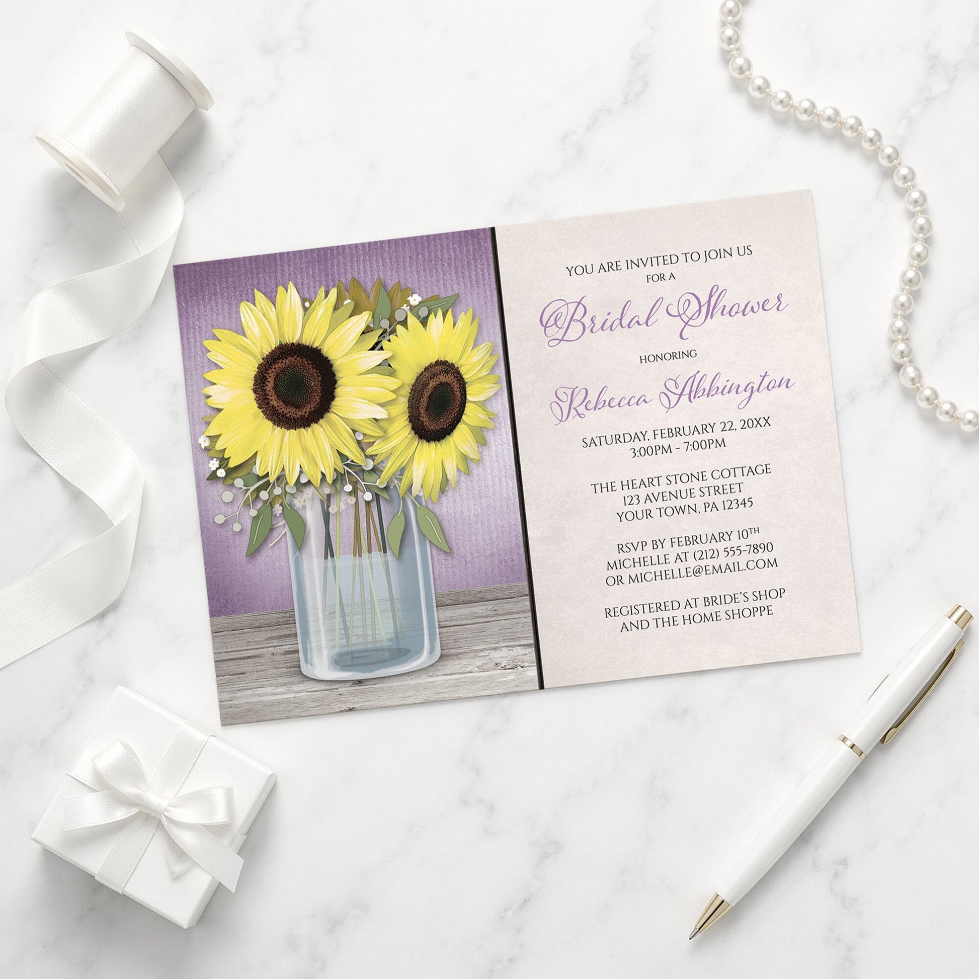 Sunflower Purple Mason Jar Rustic Bridal Shower Invitation on a marble surface with a white gift box, pen, ribbon, and pearls.