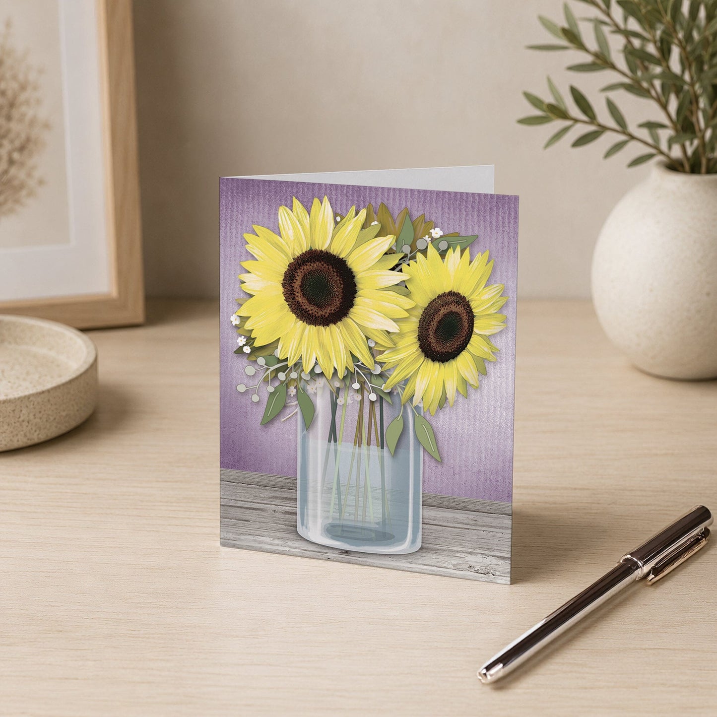 Sunflower Purple Mason Jar Rustic Note Card on a desk with a vase and a pen.