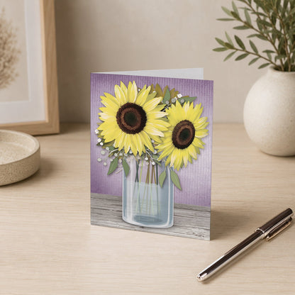 Sunflower Purple Mason Jar Rustic Note Card on a desk with a vase and a pen.