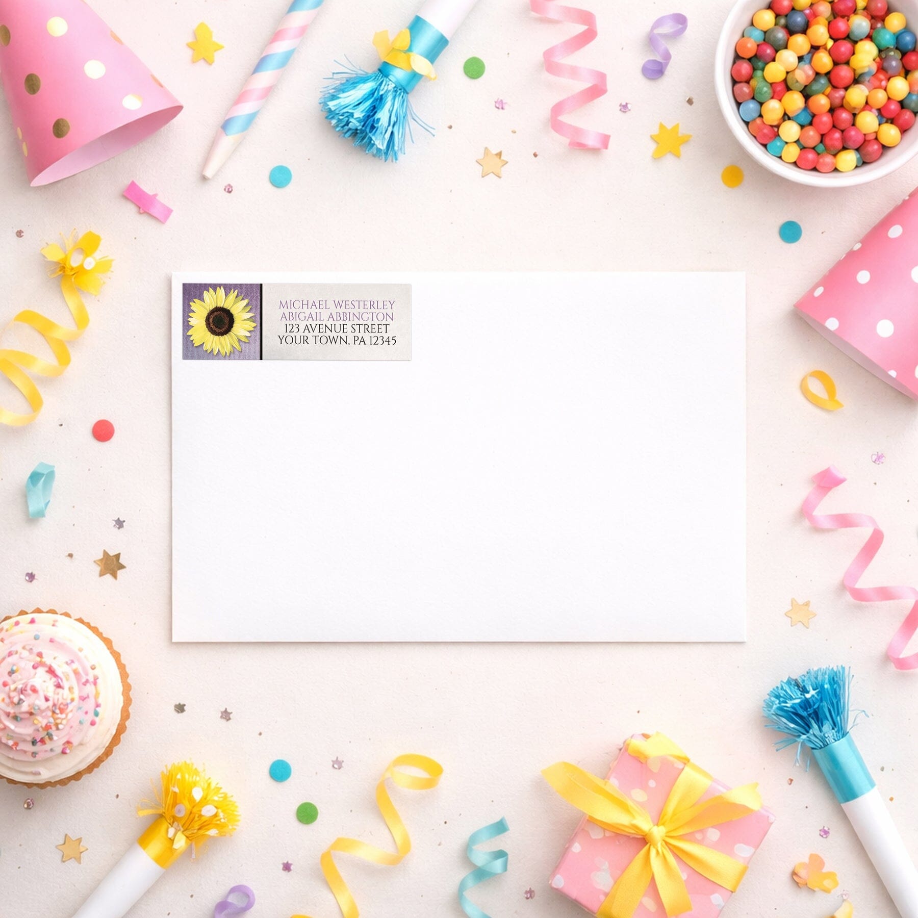 Sunflower and Purple Rustic Address Label shown on a white envelope with party supplies